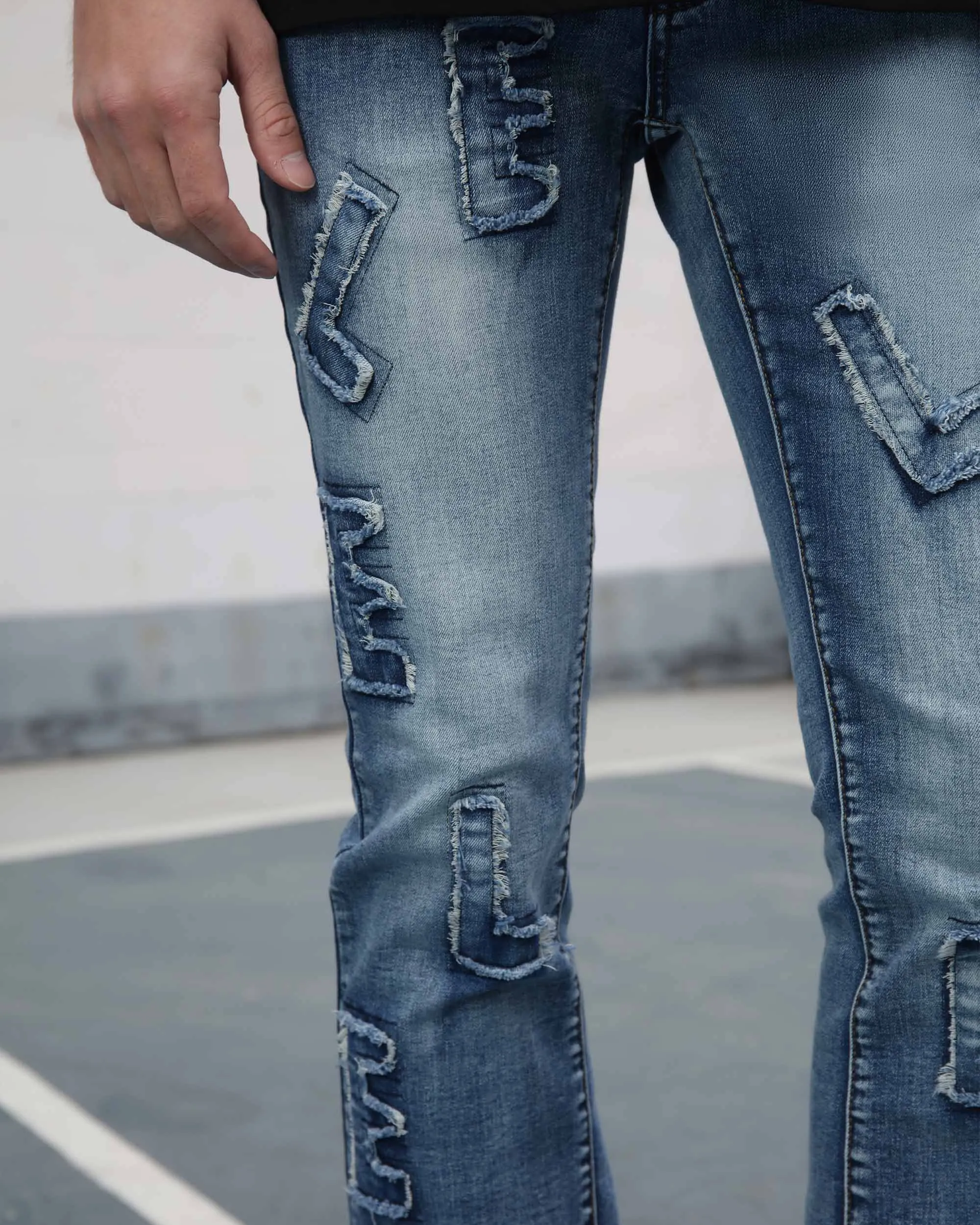 Medium Wash Blue Jeans with Ripped Text
