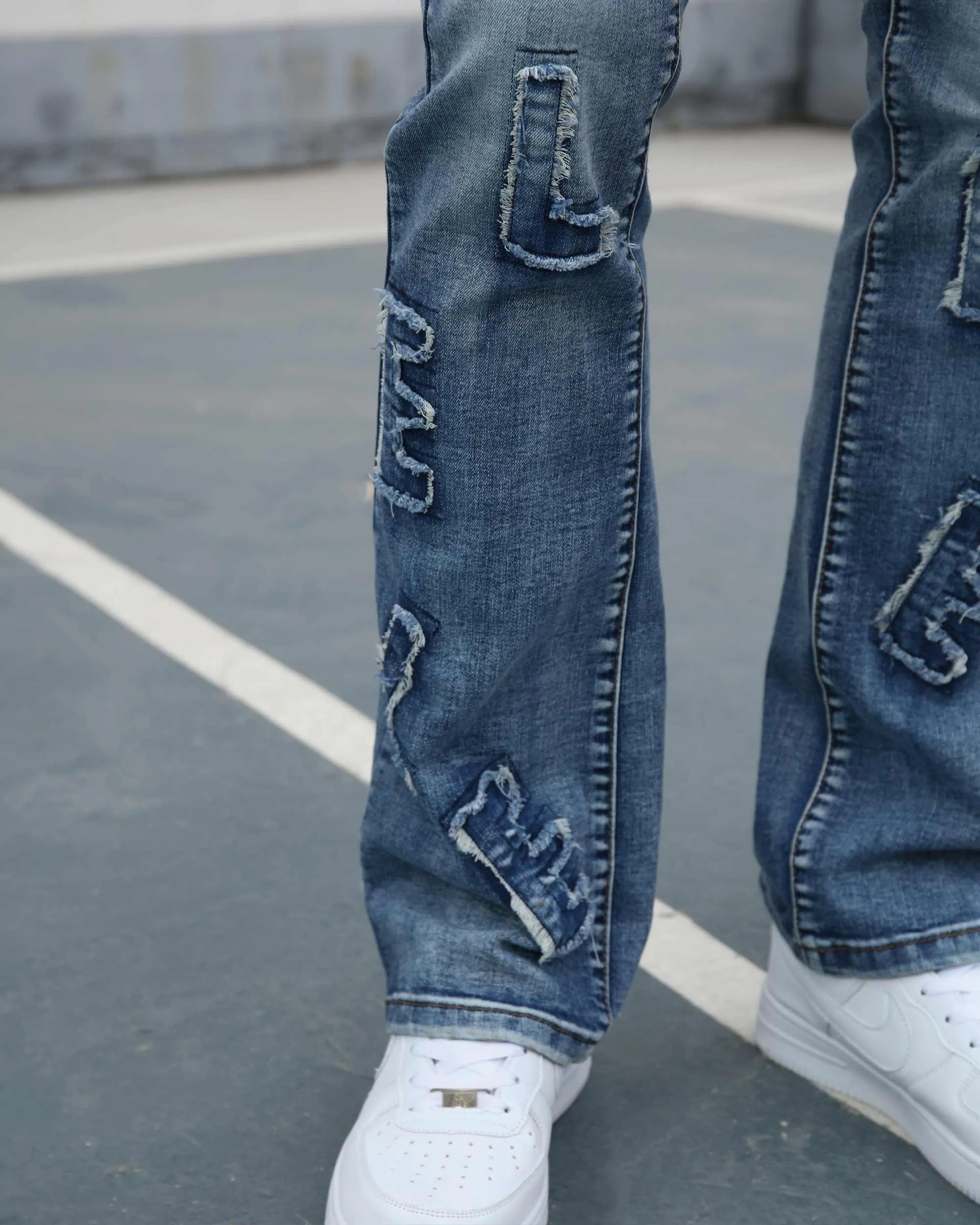 Medium Wash Blue Jeans with Ripped Text