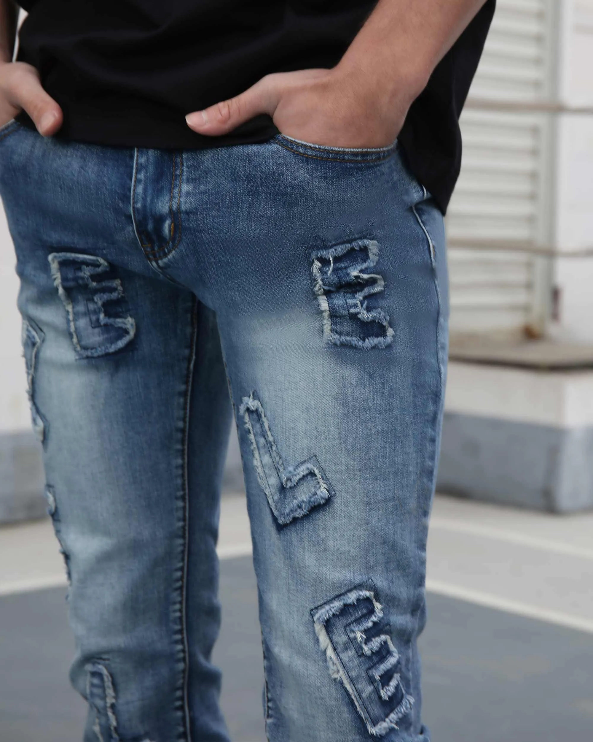 Medium Wash Blue Jeans with Ripped Text